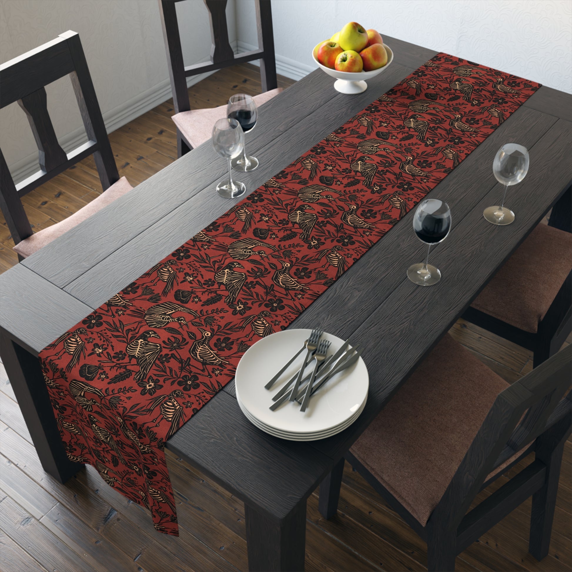 macabre autumn folk art floral bird skeleton table runner in rust red orange on a black wooden table with glasses of red wine