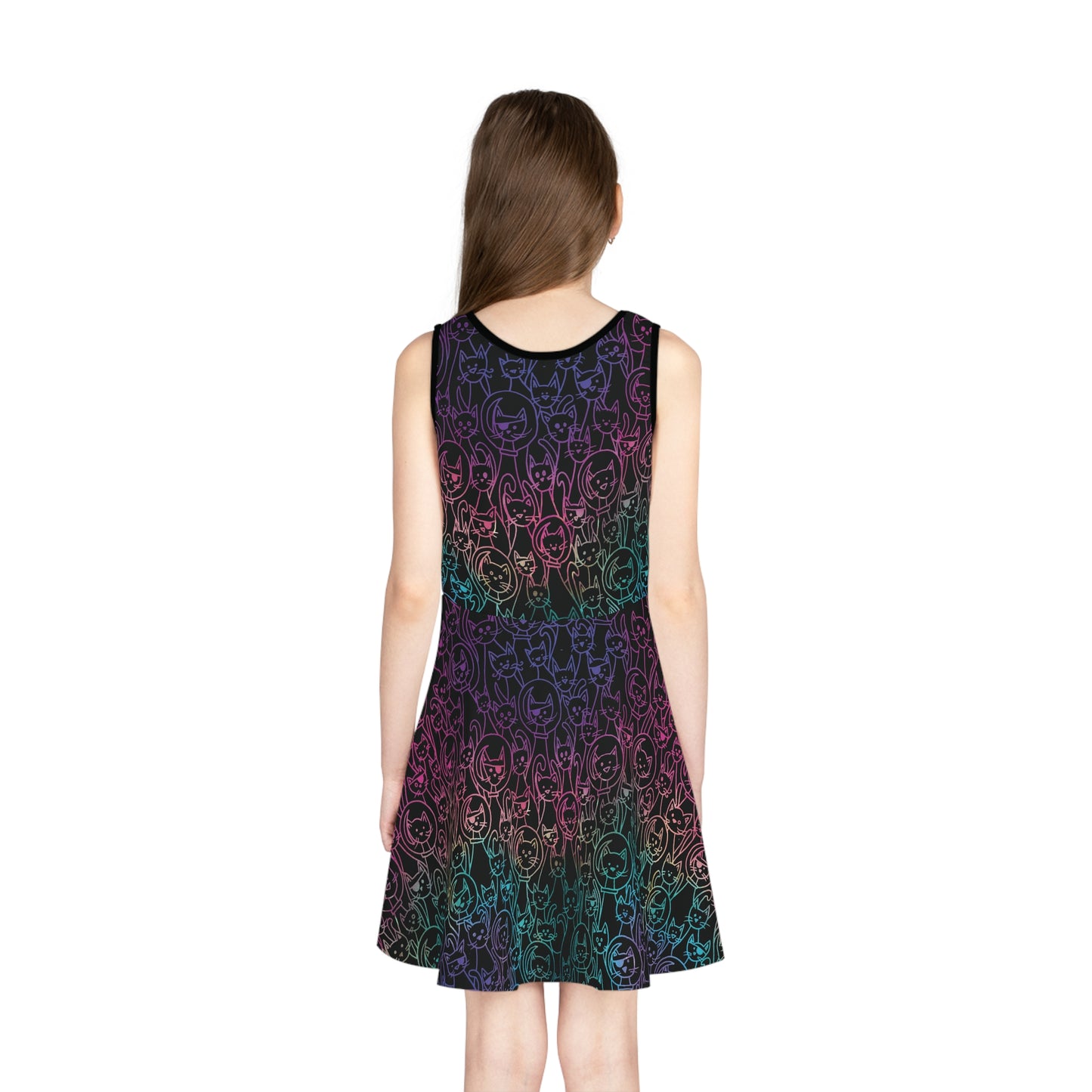 A person wearing a sleeveless kids' dress with a colorful pattern resembling cats in space