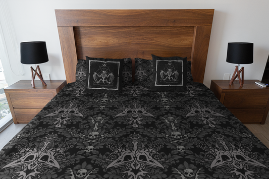 Macabre Victorian Duvet Cover bedding set in Gothic Black and Gray with occult bat skeleton throw pillows on a heavy wooden bed with dark academia nightstands and bedside lamps