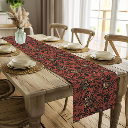 bright farmhouse style dining table with a macabre rust red table runner featuring a floral bird skull print in a folk art linocut style