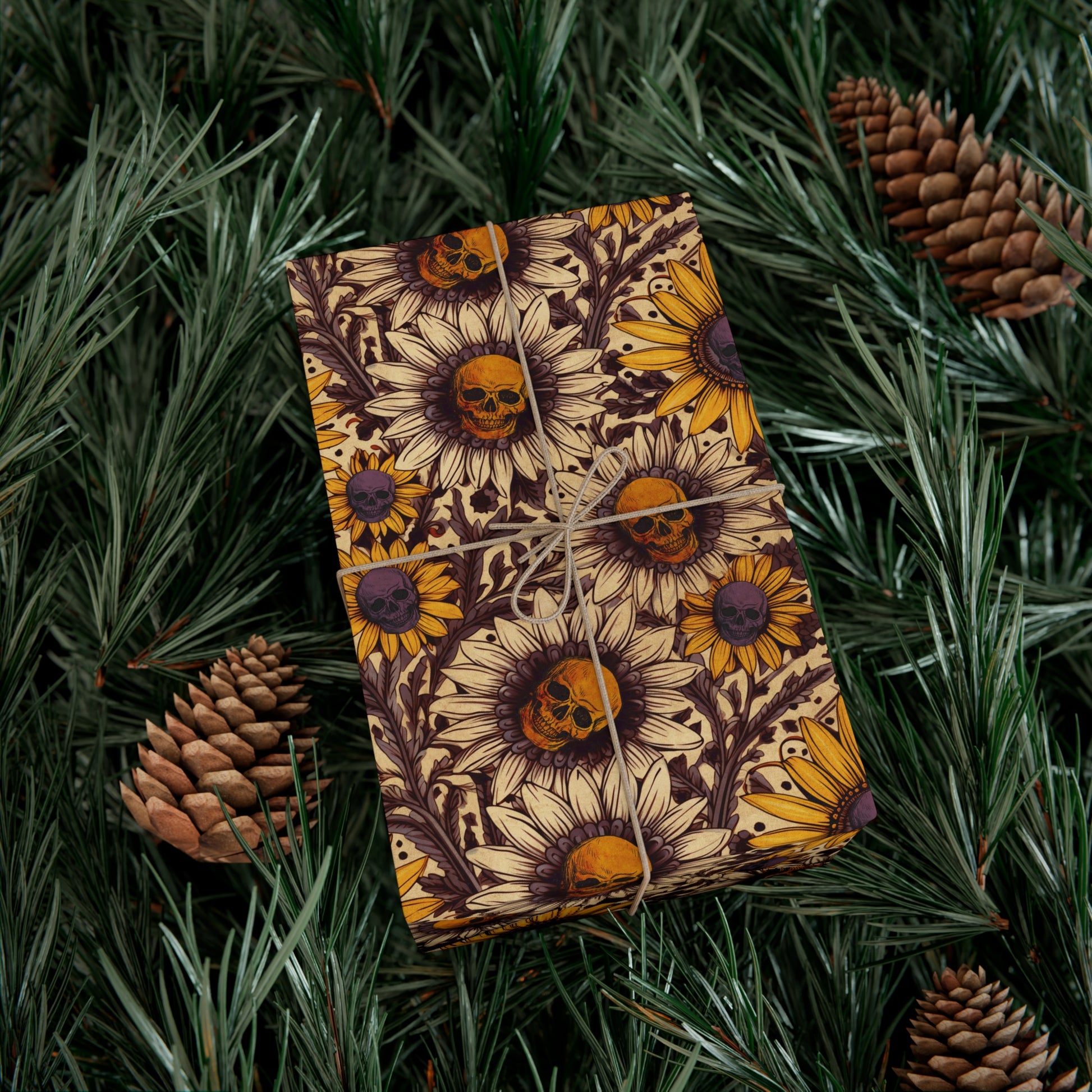 gift with sunflower and skull design on green leaves and pine cones