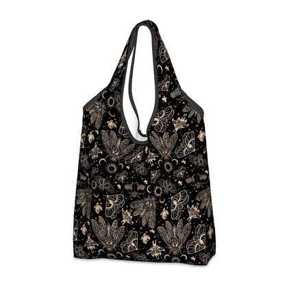 Black tote bag with a witchy cicada moth pattern on a white background