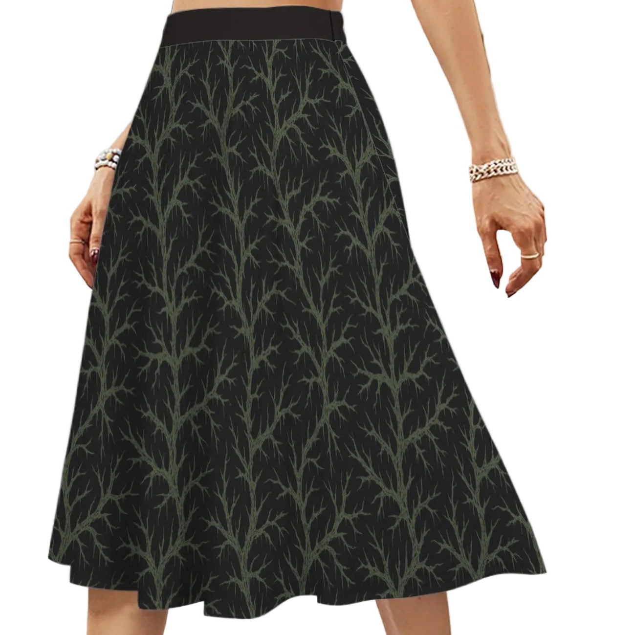 Person wearing a black skirt with witchy green vine pattern 