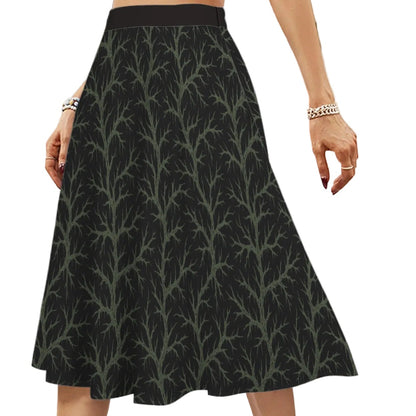 Person wearing a black skirt with witchy green vine pattern 