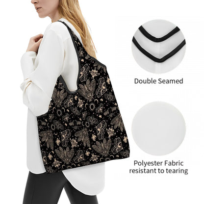 Person wearing a black shopping tote bag with a gothic moth design, showing double-seamed construction and polyester fabric.