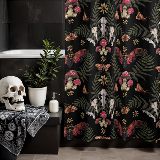 Bathroom with a dark shower curtain featuring skull and nature patterns, skull on a shelf, and plant.