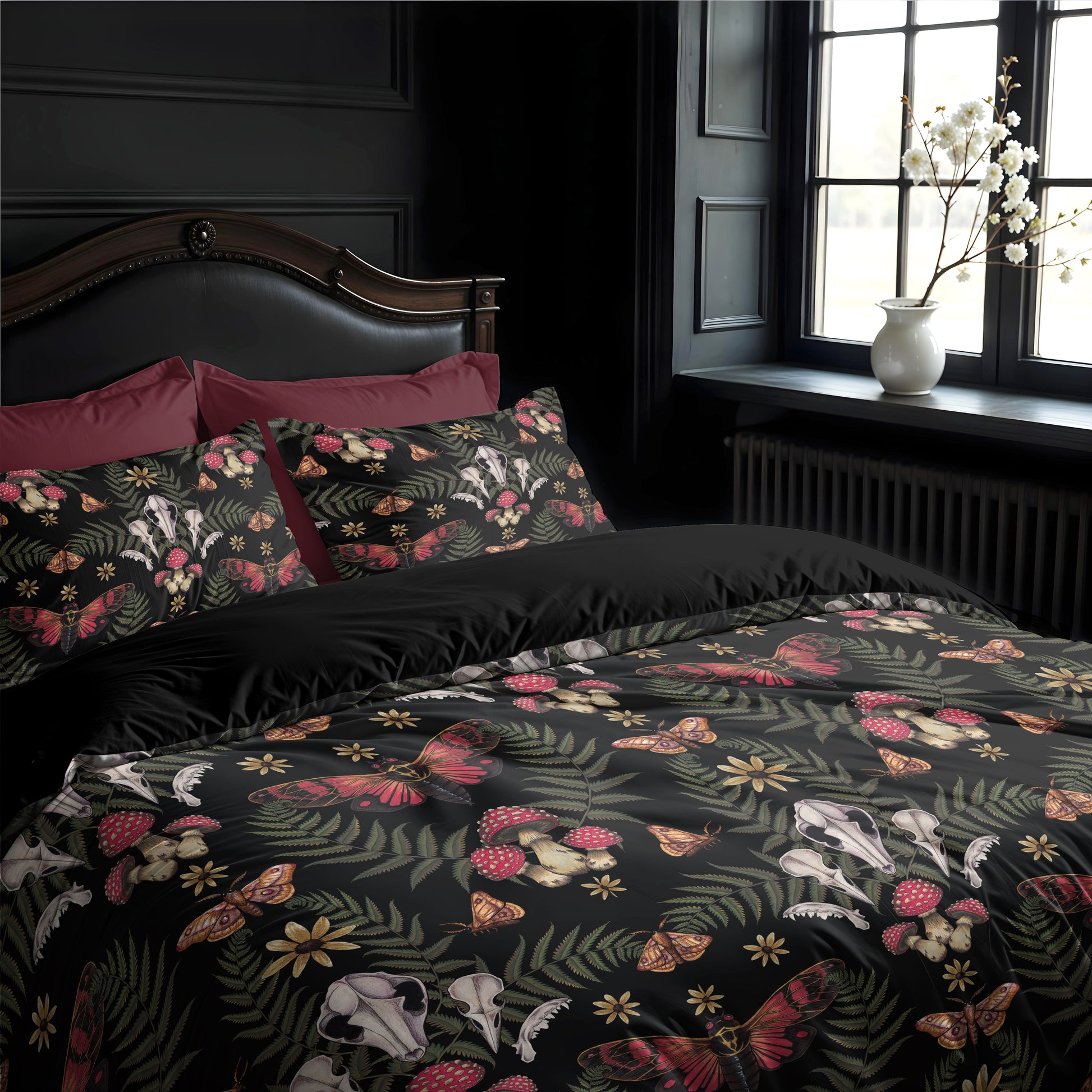 Bedroom with dark cottagecore floral and skull patterned bedding and pillows.