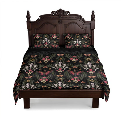 Bed with floral, cicada, skull, and mushroom patterned bedding on a baroque bedframe