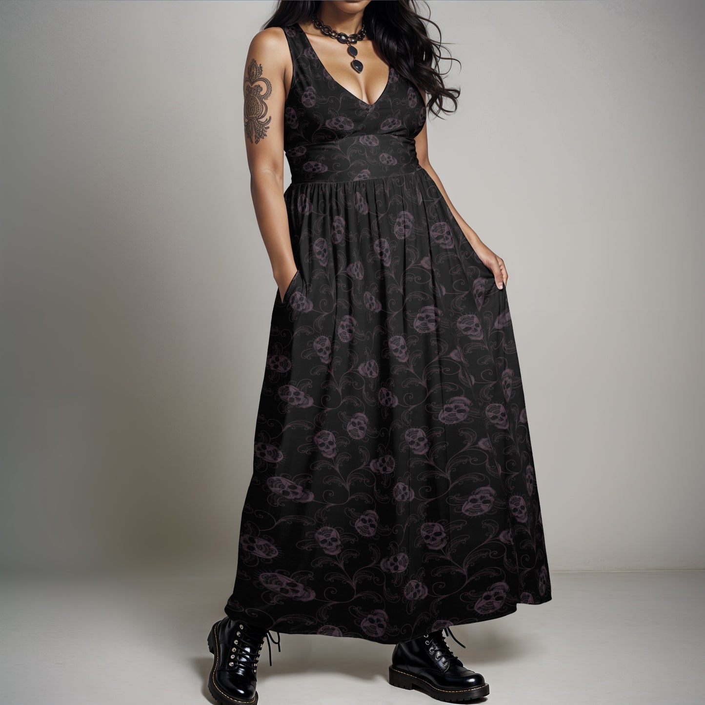 dark ornate goth skull sleeveless maxi-dress with pockets on a plus sized gothic woman wearing combat boots