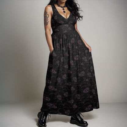 dark ornate goth skull sleeveless maxi-dress with pockets on a plus sized gothic woman wearing combat boots