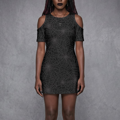 Goth Woman wearing a black spider web cold shoulder dress with spooky vibes against a gray background