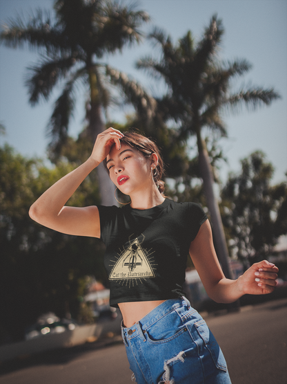 Woman wearing a black t-shirt with a witchy black widow design outdoors with palm trees in the background