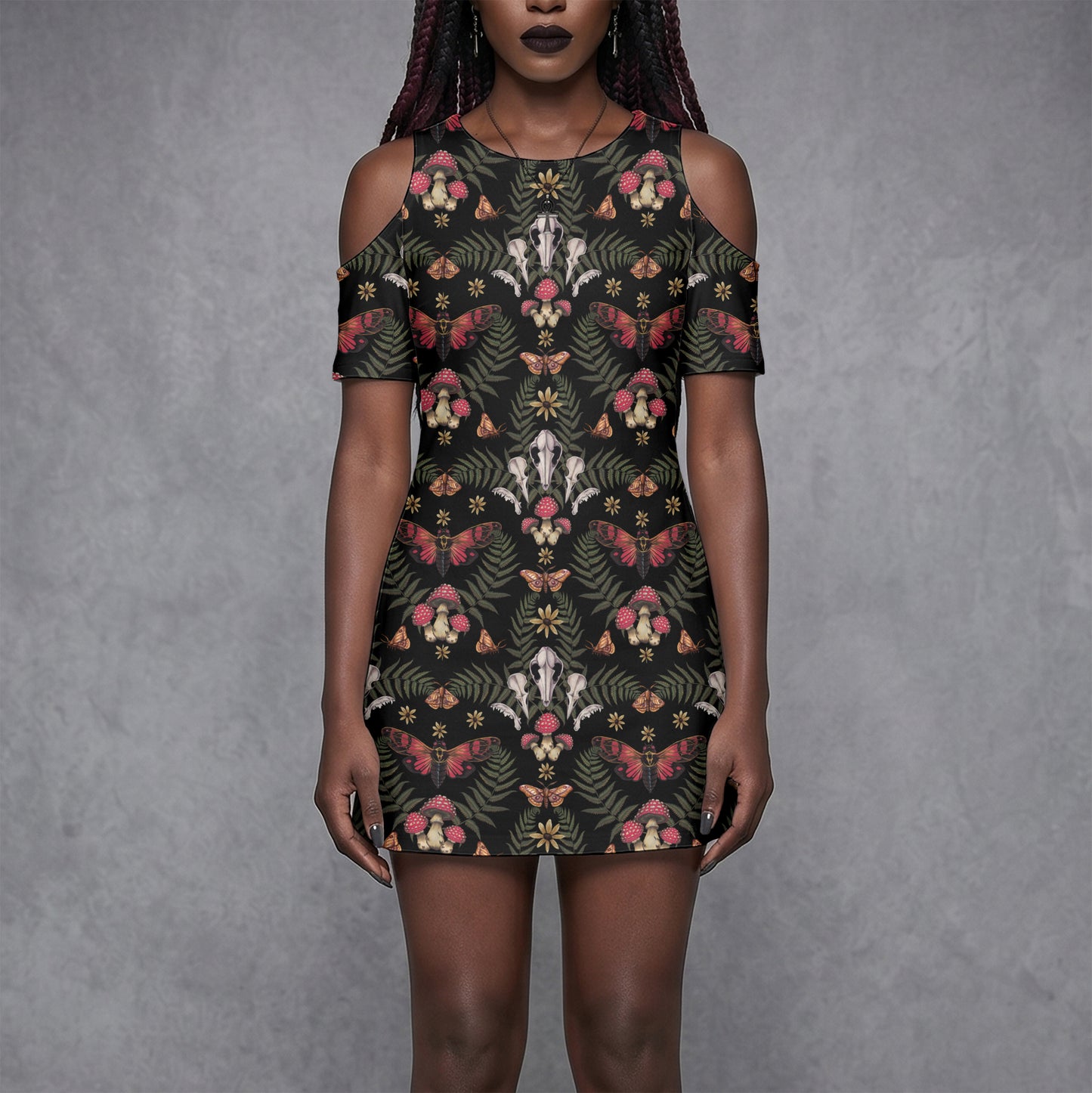 goth woman wearing a witchy floral skull mushroom moth patterned dress against a gray background
