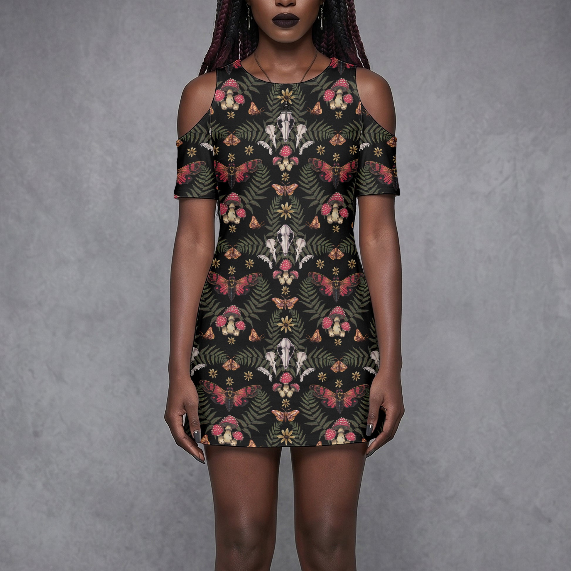 goth woman wearing a witchy floral skull mushroom moth patterned dress against a gray background