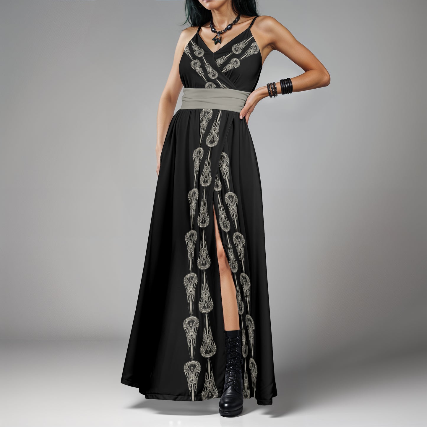 A strikingly elegant and delightfully spooky gothic dress featuring a print of hand drawn carved raven skulls in black and earthy gray on a witchy woman with dark blue hair