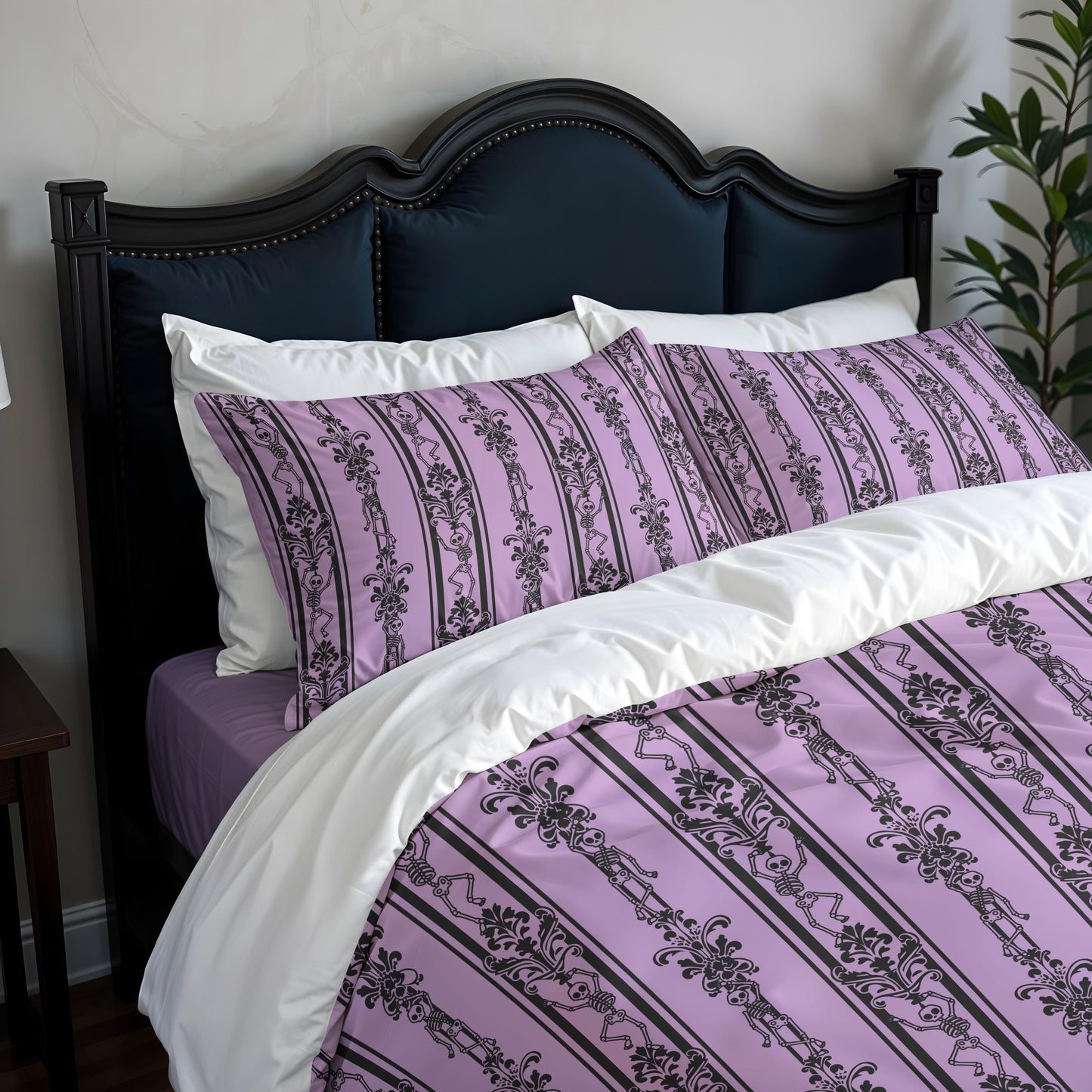 Bed with gothic skeleton purple and white patterned bedding and pillows against a dark headboard.