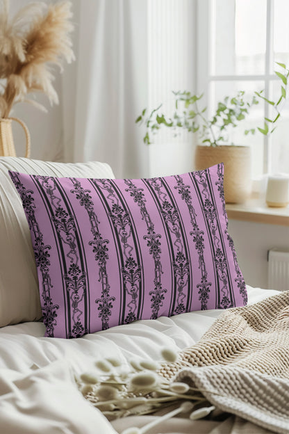 Decorative pink pillow with black skeleton patterns on a white couch in a bright room.