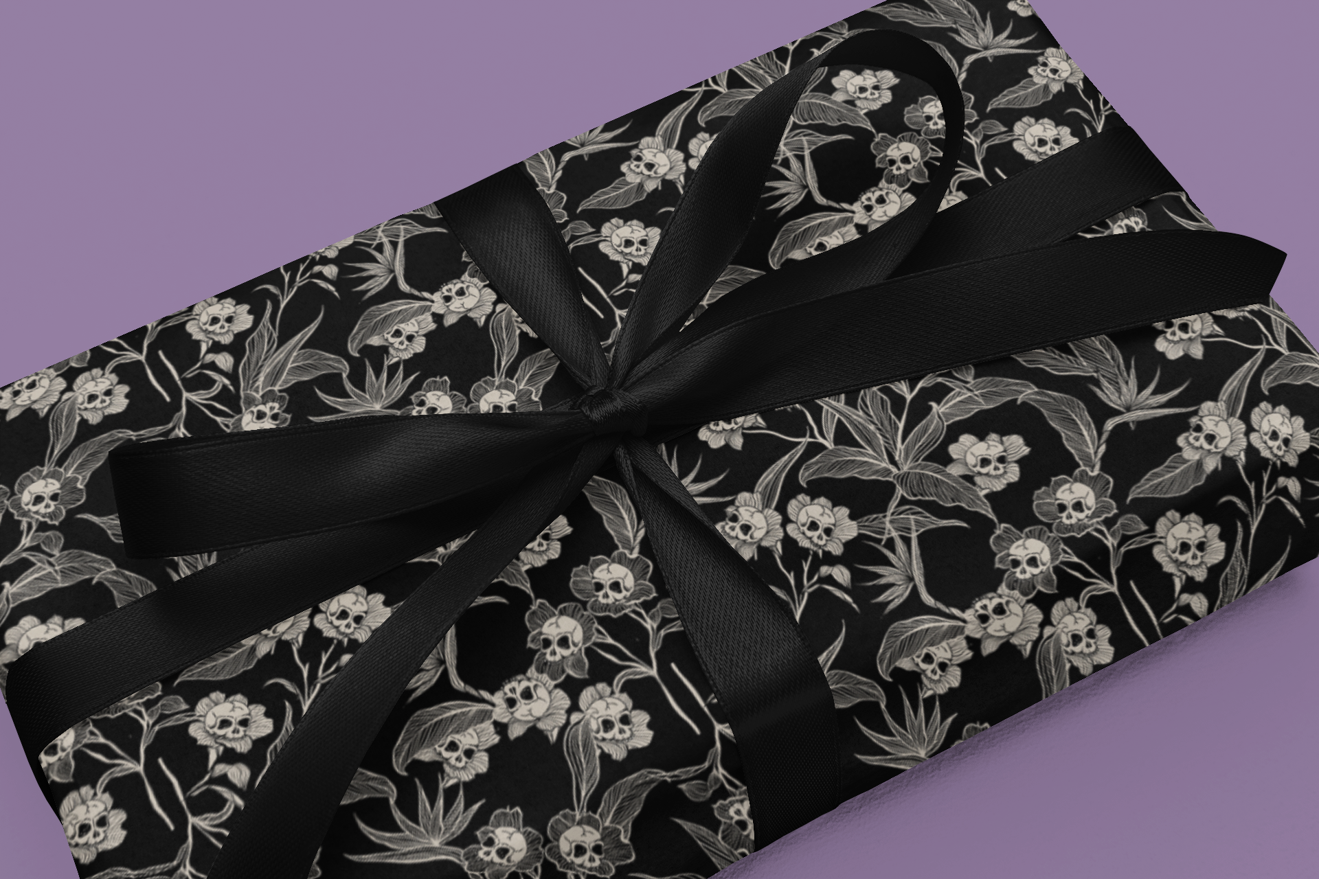 Gift wrap with black gothic floral pattern and black ribbon on a purple background