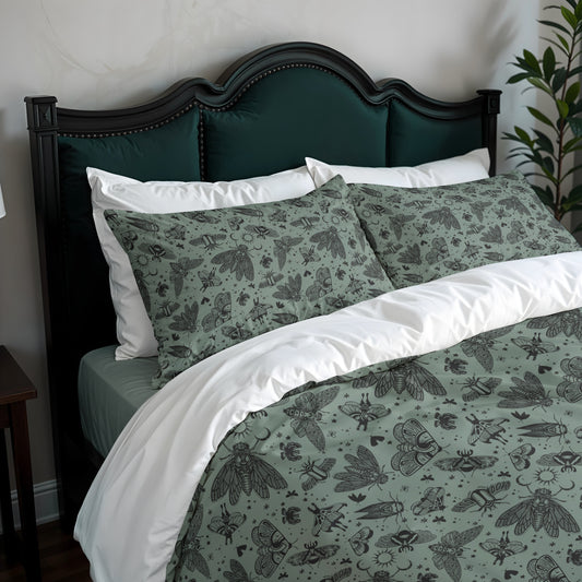 Bed with green and white bedding featuring moth patterns, dark wood headboard, and plant in corner.