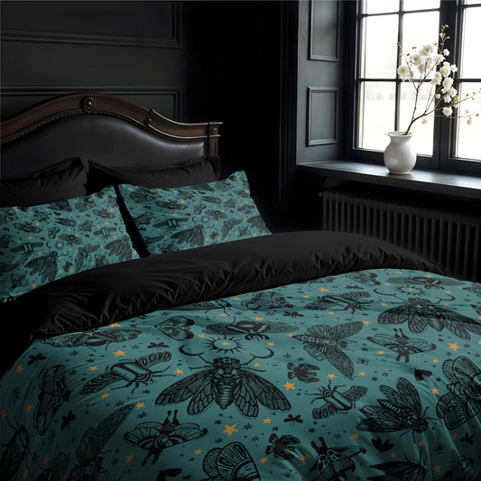 Bed with teal bedding featuring black witchy cicada and moth pattern, in a darkly decorated gothic room with a window and vase.