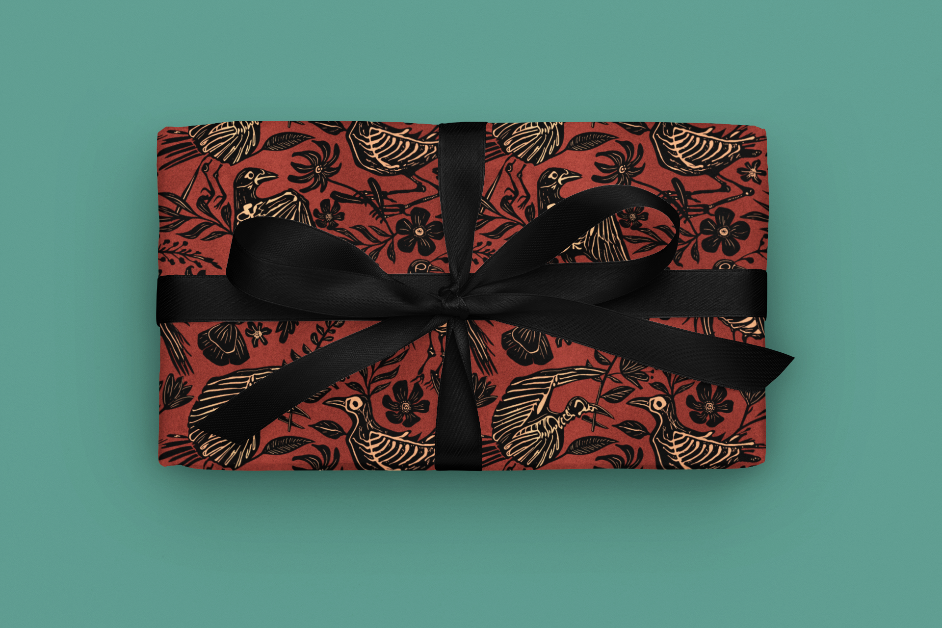 Gift with gothic red floral skeleton pattern and black ribbon on a teal background