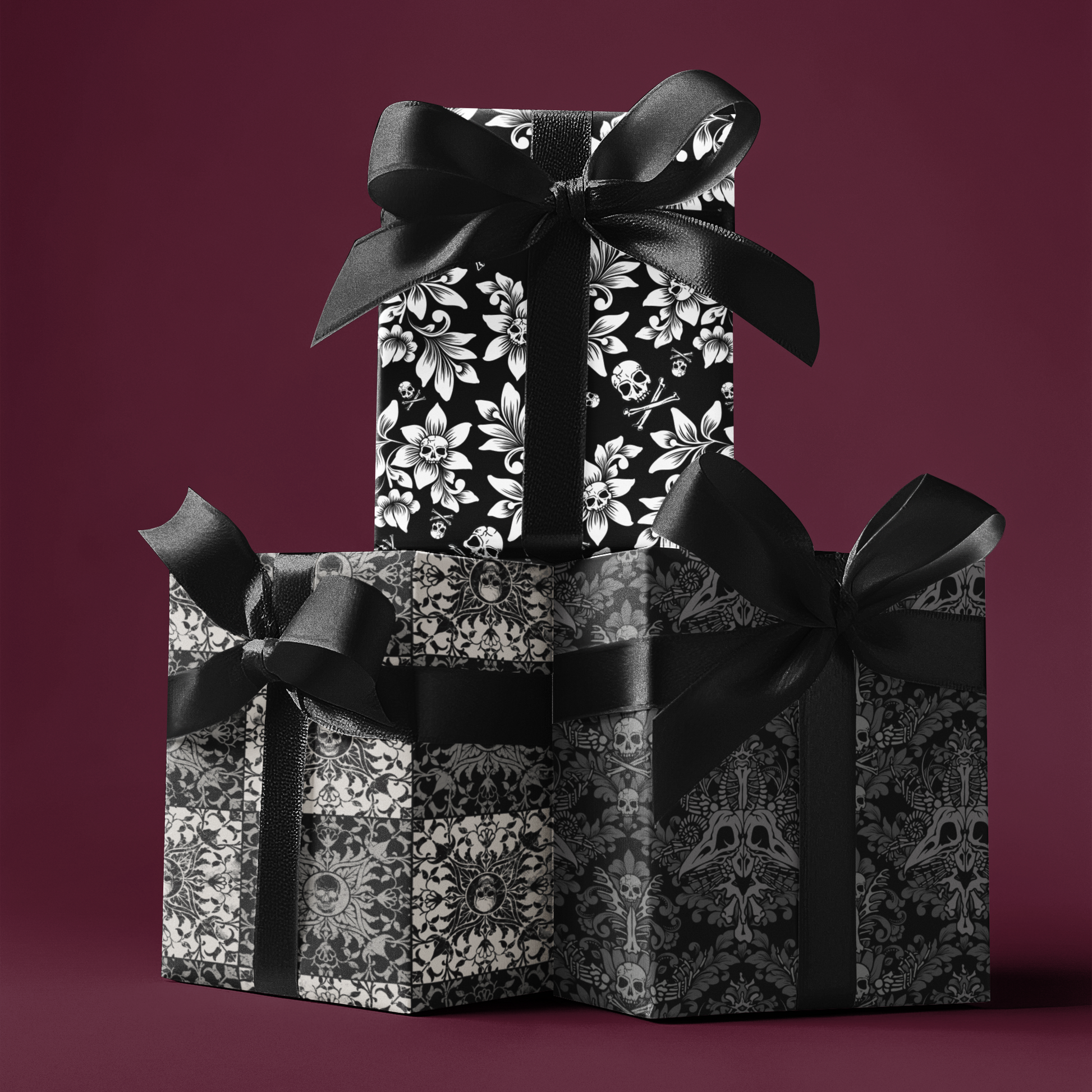 Three gift boxes with spooky gothic wrapping paper and black ribbons on a dark red background