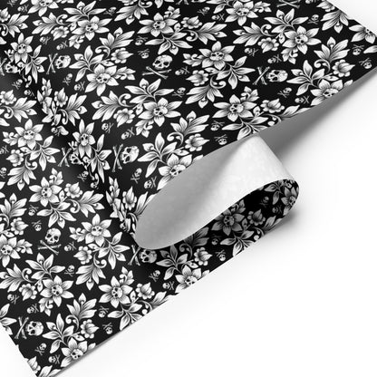 Black wrapping paper with white floral and skull pattern
