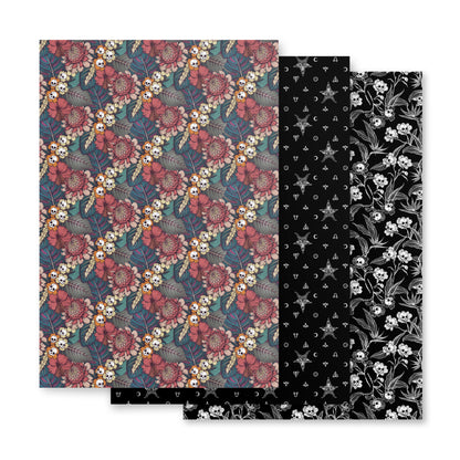 Two patterned paper sheets with floral and skull designs on a white background.