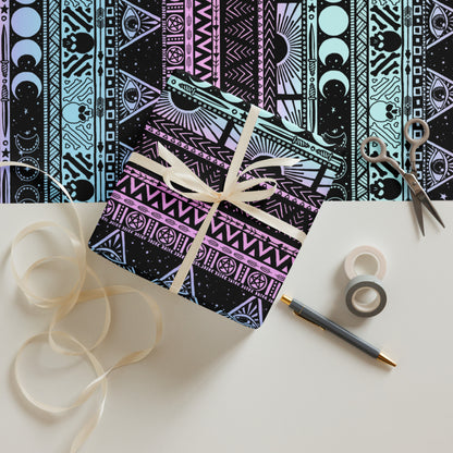 Decorative box with a witchy pastel patterned design, ribbon, scissors, and tape on a white surface.