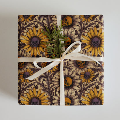 Gift wrapped in paper with sunflower and skull design on a plain background