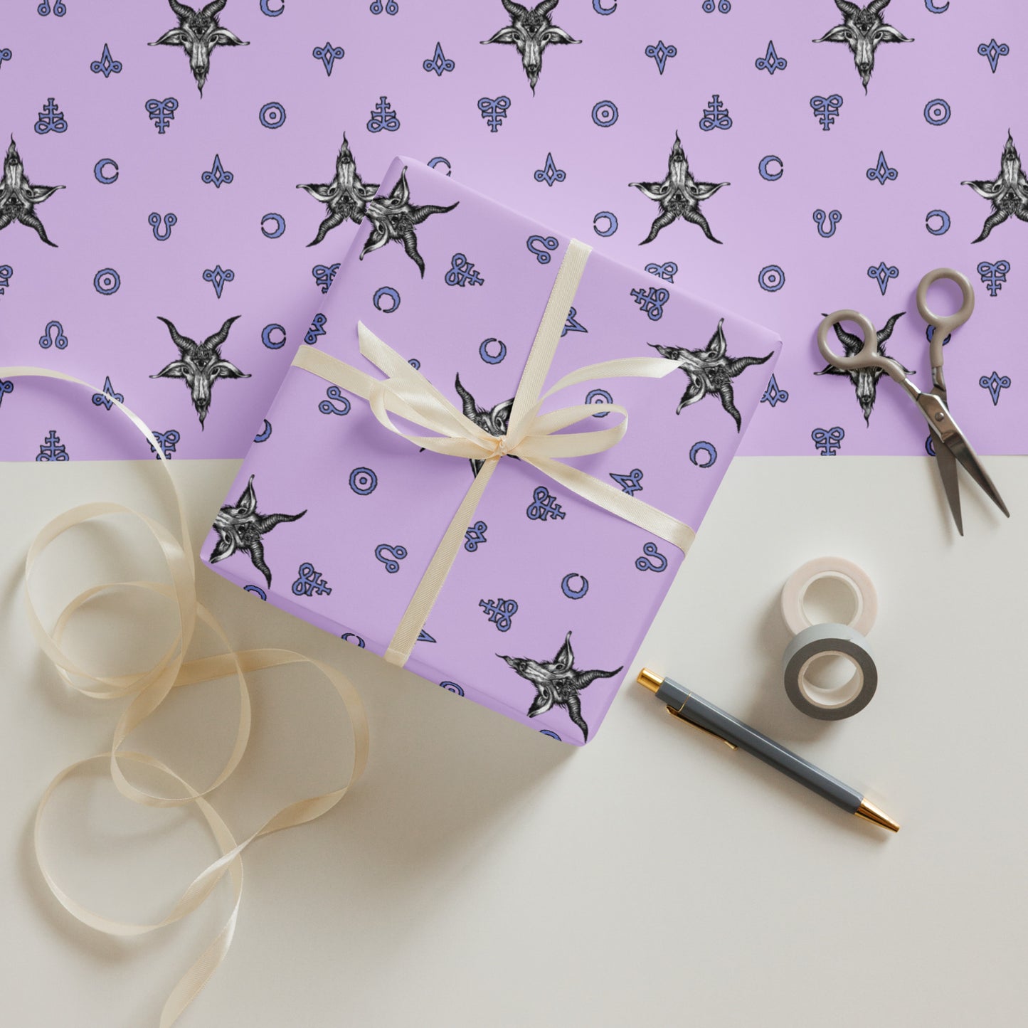 pink satanic Gift box with decorative ribbon on a white surface with purple wrapping paper and star pattern.