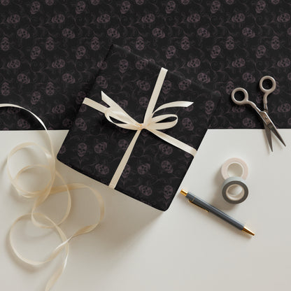 Gift box with skull pattern, ribbon, scissors, and tape on a matching background