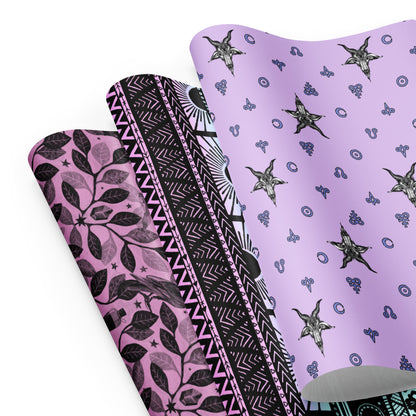 Three sheets of pastel goth gift wrap on a white background