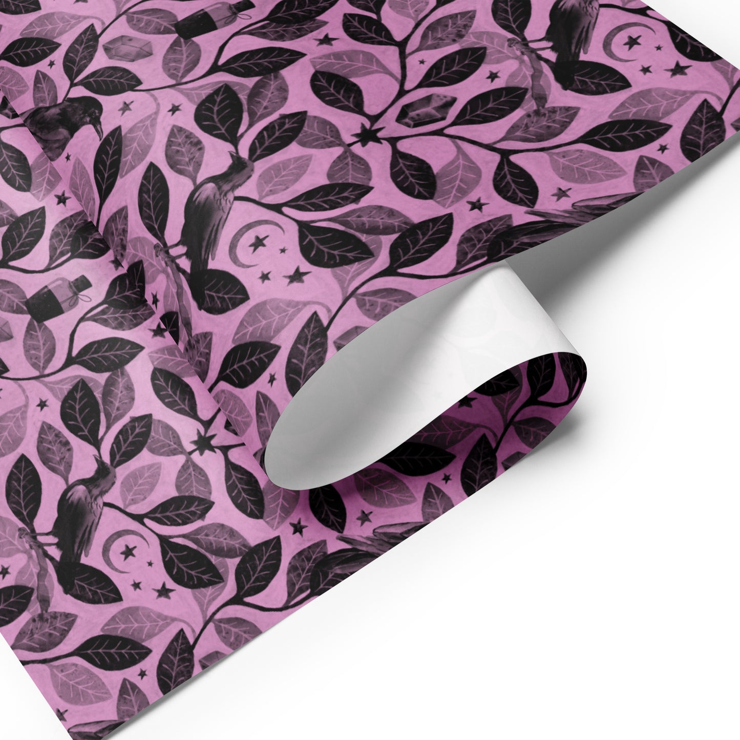 Pink wrapping paper with witchy black leaf pattern